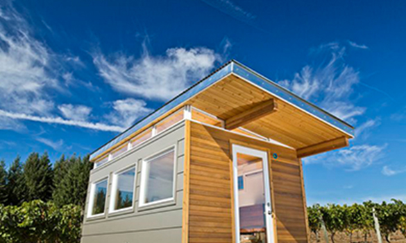 Modern prefab shed with clerestory windows and wood siding