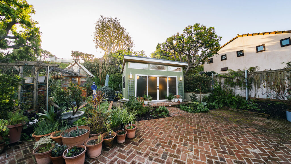 Garden view with prefab shed and brick patio