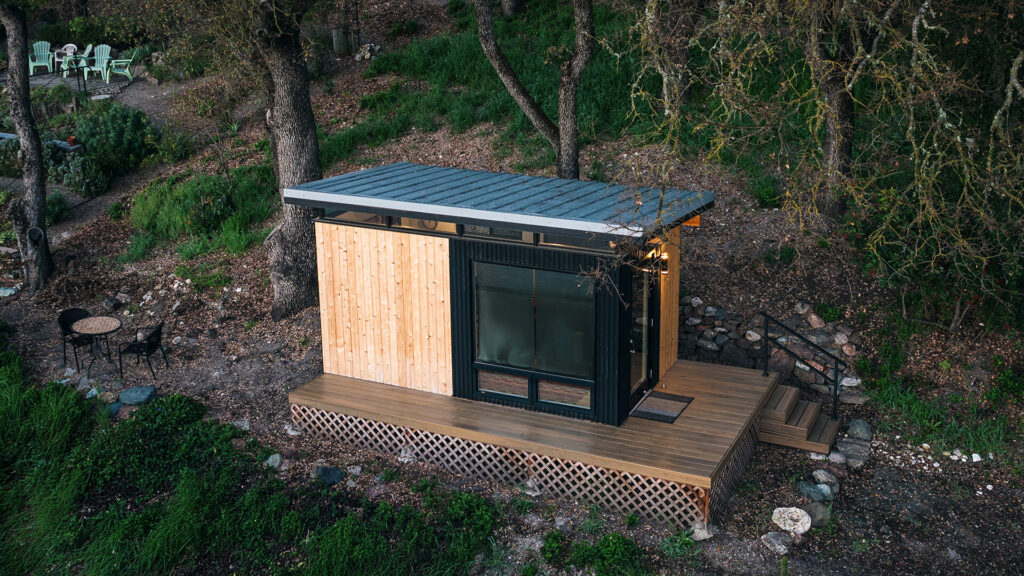 Contemporary shed cabin with wood siding in natural setting