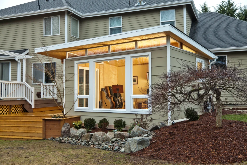 Modern backyard studio attached to house with large windows