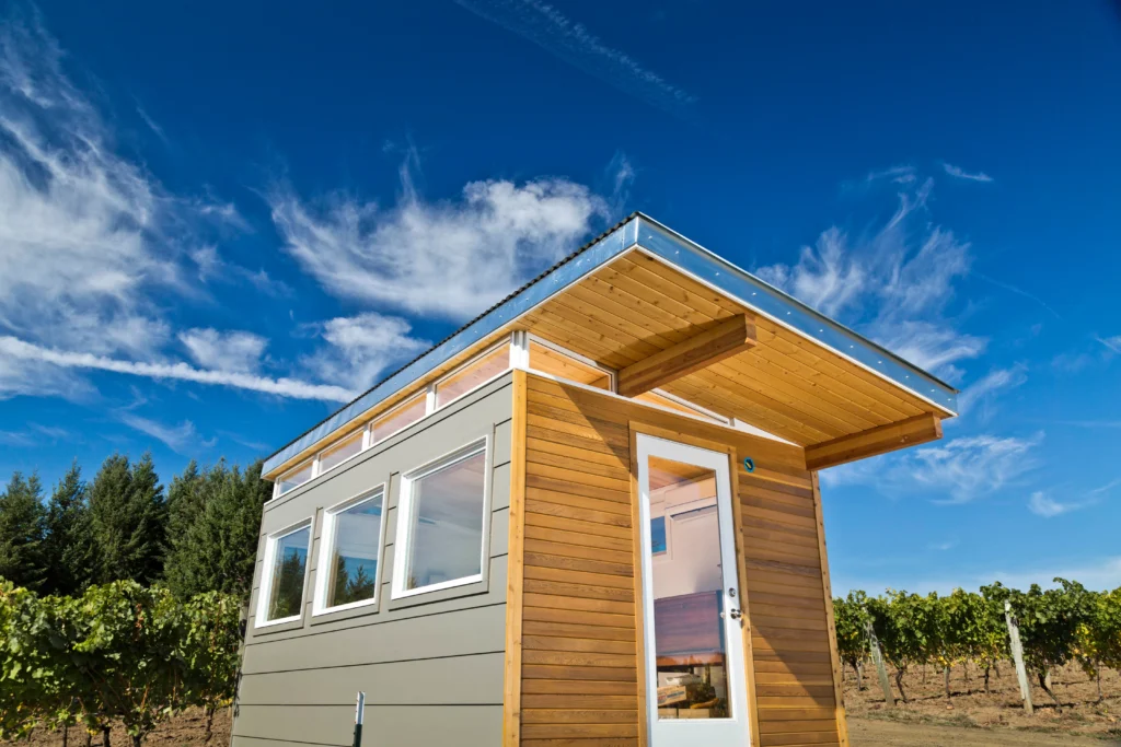 Modern prefab shed with wood siding in vineyard setting