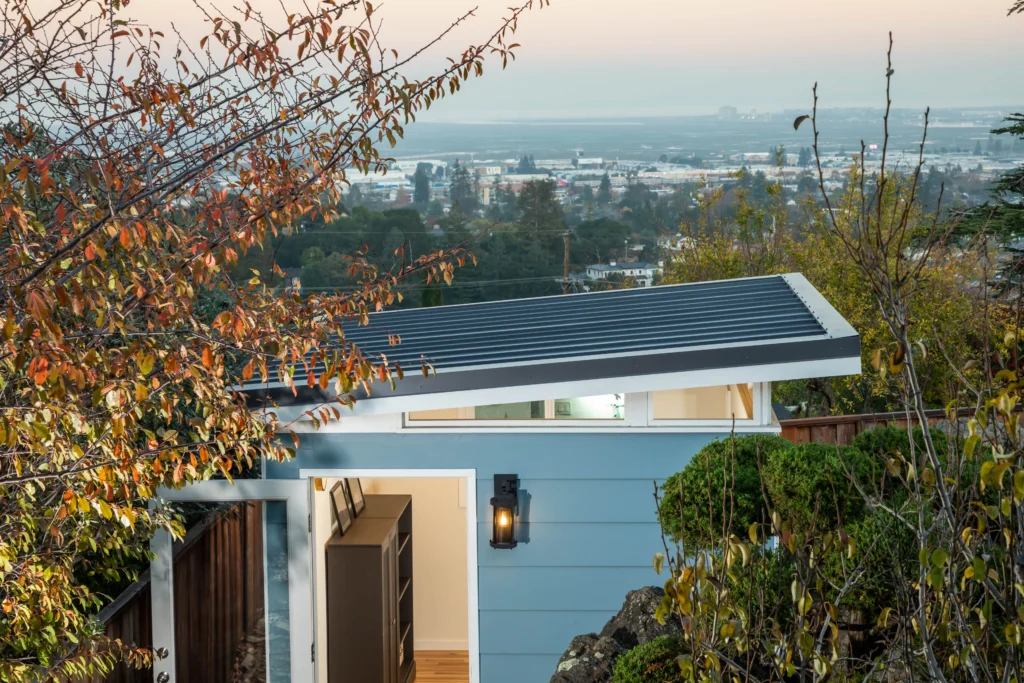 Contemporary hillside shed with city view and open doorway