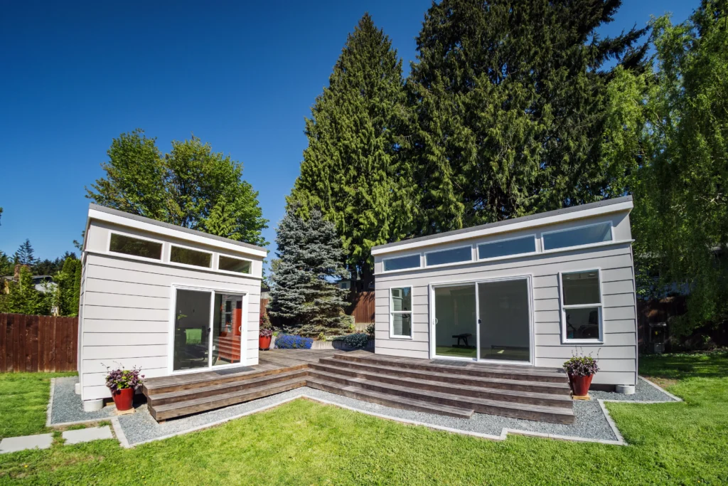 Dual modern backyard office pods with shared outdoor steps